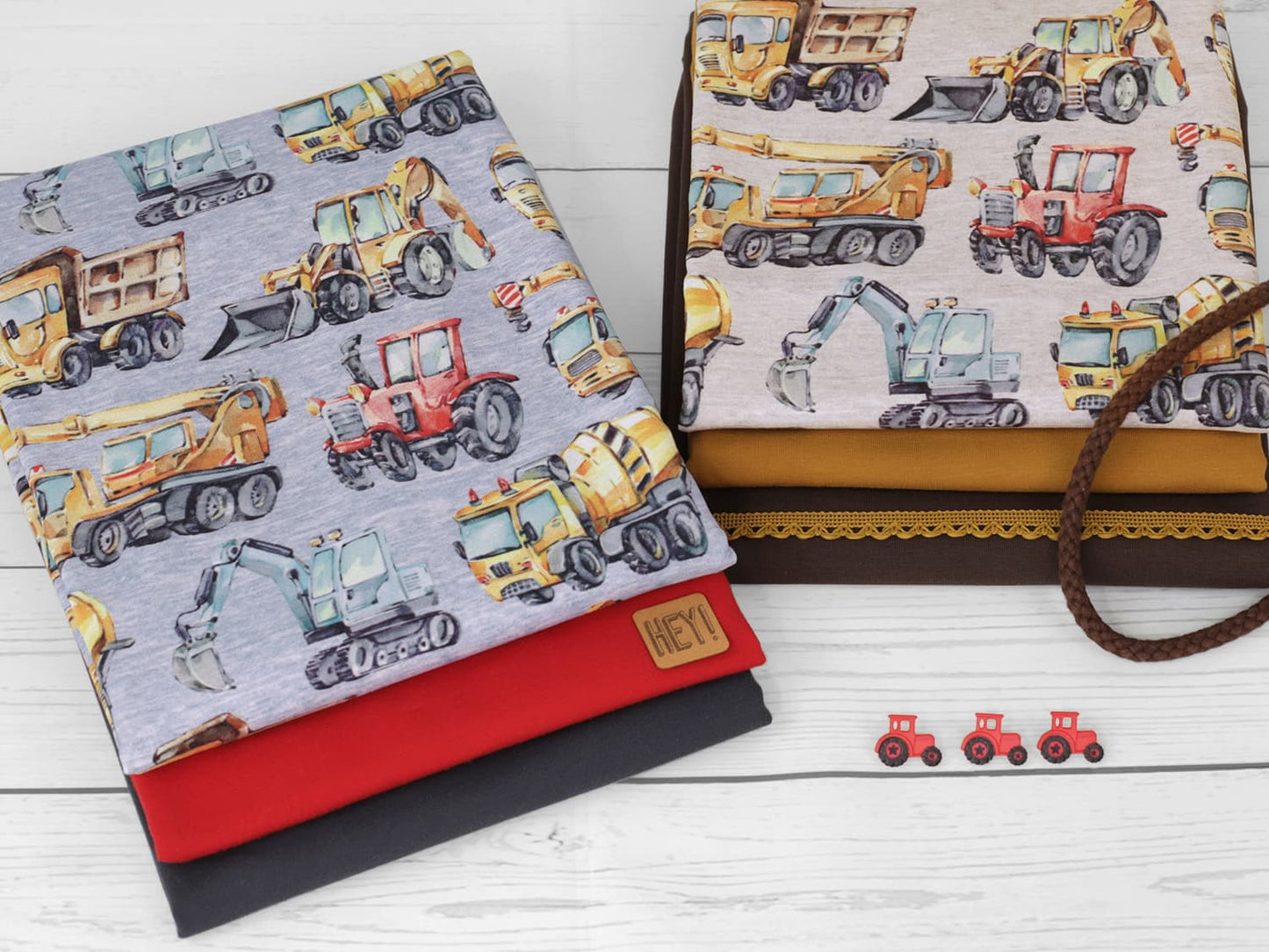 stoff-french-terry-sweat-sommersweat-unangeraut-baufahrzeuge-autos-traktor-bagger-betonmischer-meliert-serie