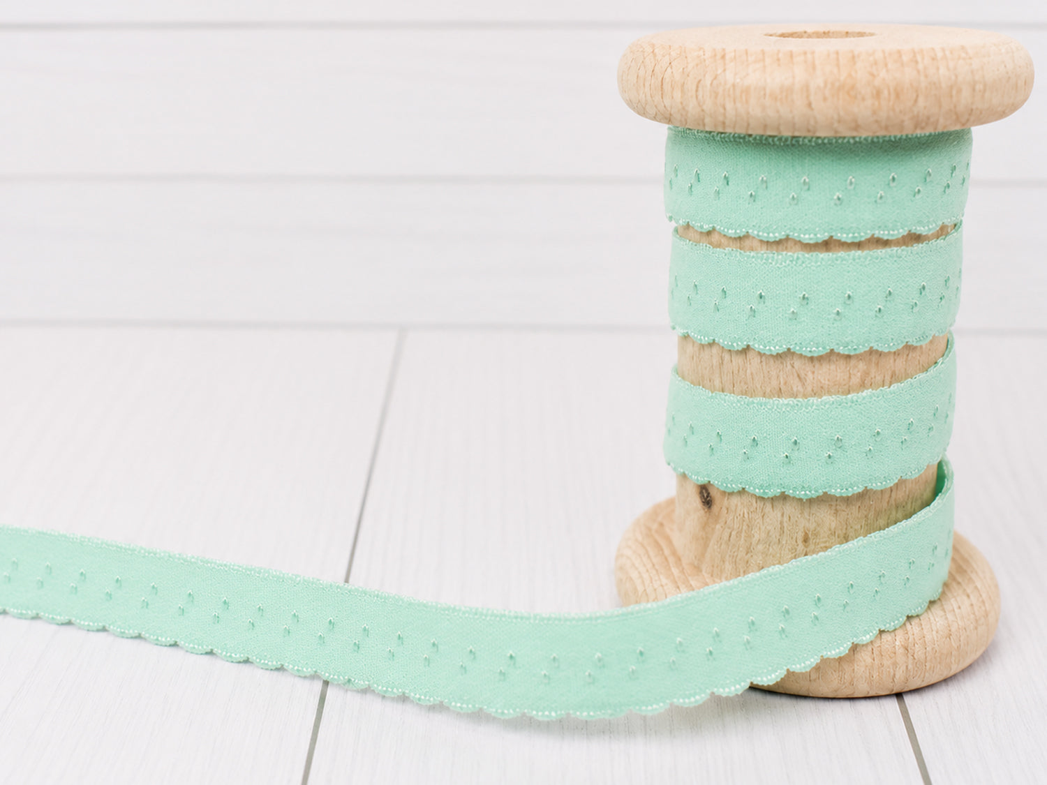 mint elastisches einfassband auf Holzspule, dekoratives Design mit Bogenkante, 11 mm breit, ideal für Bastelprojekte.