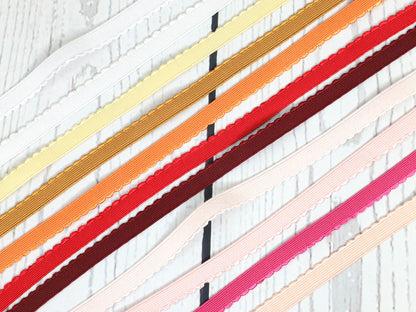 12mm apricot gummiband mit bogenkante in verschiedenen Farben auf Holzuntergrund