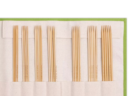 Bamboo knitting needle set 2-4.5 mm neatly arranged in a cotton storage bag for easy access and organization.