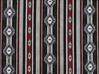 Patchworkstoff - Baumwolle Stoff - Cabin in a patterned design with bold colors and geometric motifs.