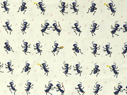 party ants cotton jersey fabric featuring playful black ants dancing on a cream background.