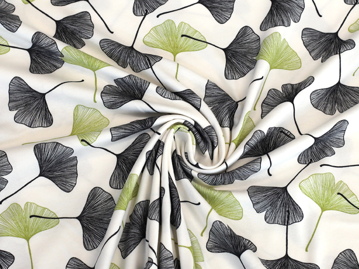 ginkgo cotton jersey fabric with black and green ginkgo leaves on a cream background