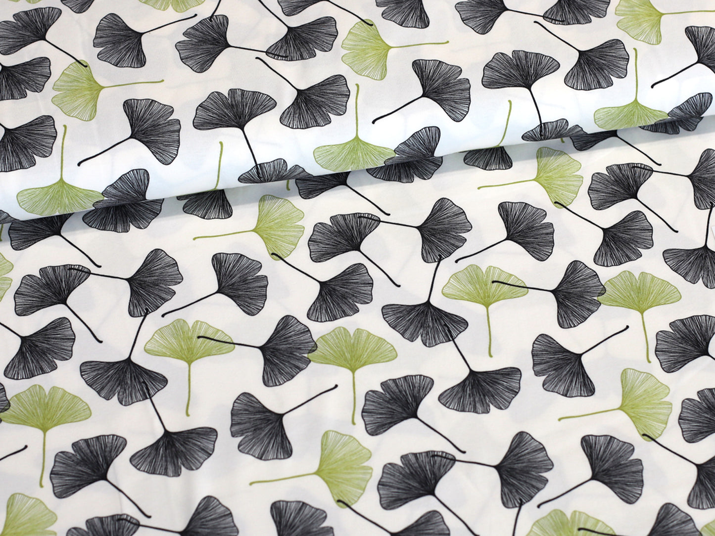 ginkgo cotton jersey fabric featuring beautiful ginkgo leaves on a cream background, ideal for stylish sewing projects.
