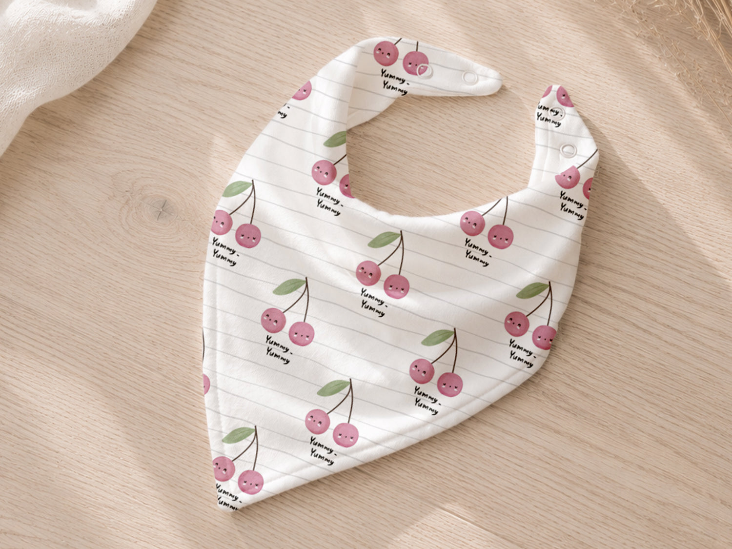 lightweight cherry print jersey fabric in a stylish bib design with pink cherries on a white background.