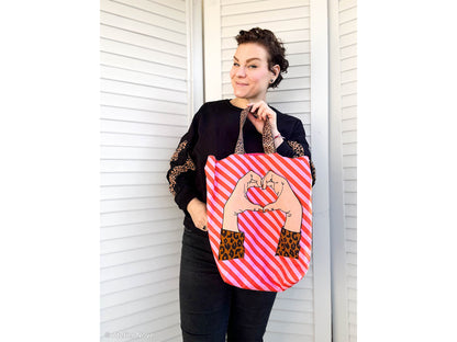 Person holding a Jersey PANEL - Cherry Picking Bag - DIY-Panel, showcasing a fun design, perfect for DIY enthusiasts.