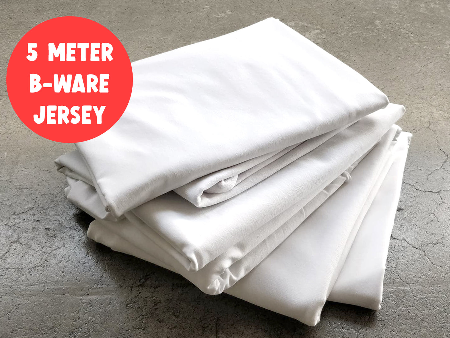 5m B-WARE Paket - Uni Jersey - weiß, verschiedene weiße Jersey-Stücke auf einem Tisch.