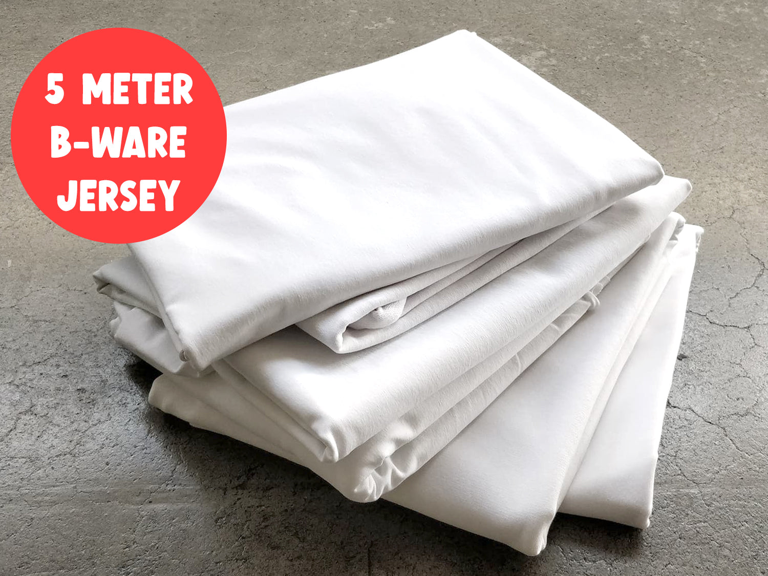 5m B-WARE Paket - Uni Jersey - weiß, verschiedene weiße Jersey-Stücke auf einem Tisch.